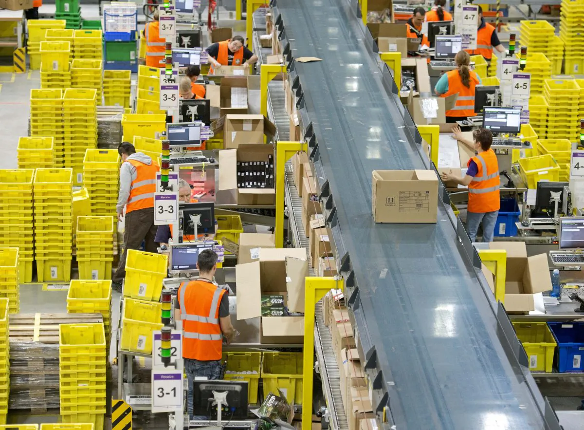 Employees work in a distribution center of Amazon in Leipzig, central Germany, March 26. (AP Photo/Jens Meyer)