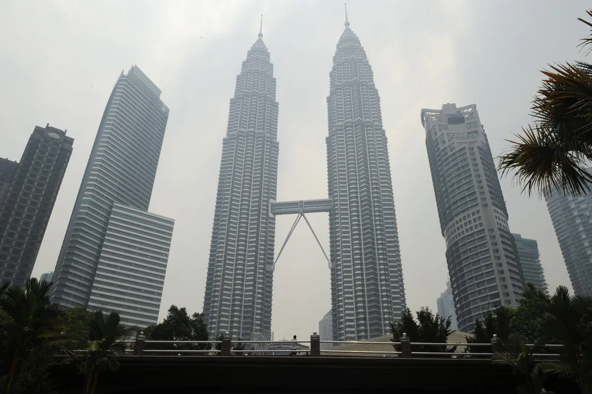 Malaysia's landmark Petronas Twin Towers (C) are covered with light haze in Kuala Lumpur on July 23, 2013. An incident involving diplomatic immunity has caused an uproar in both Malaysia and New Zealand. (Mohd Rasfan/AFP/Getty Images)