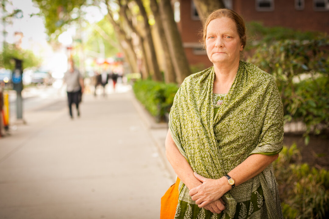 Falun Gong practioner Christiane Teich, from India, poses on a street in New York City on May 19, 2014. (Benjamin Chasteen/Epoch Times)