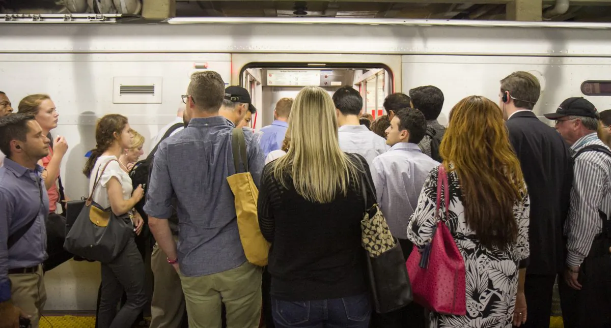 Commuters board a Long Island Rail Road train at Penn Station in Manhattan on July 17. (Benjamin Chasteen/Epoch Times)