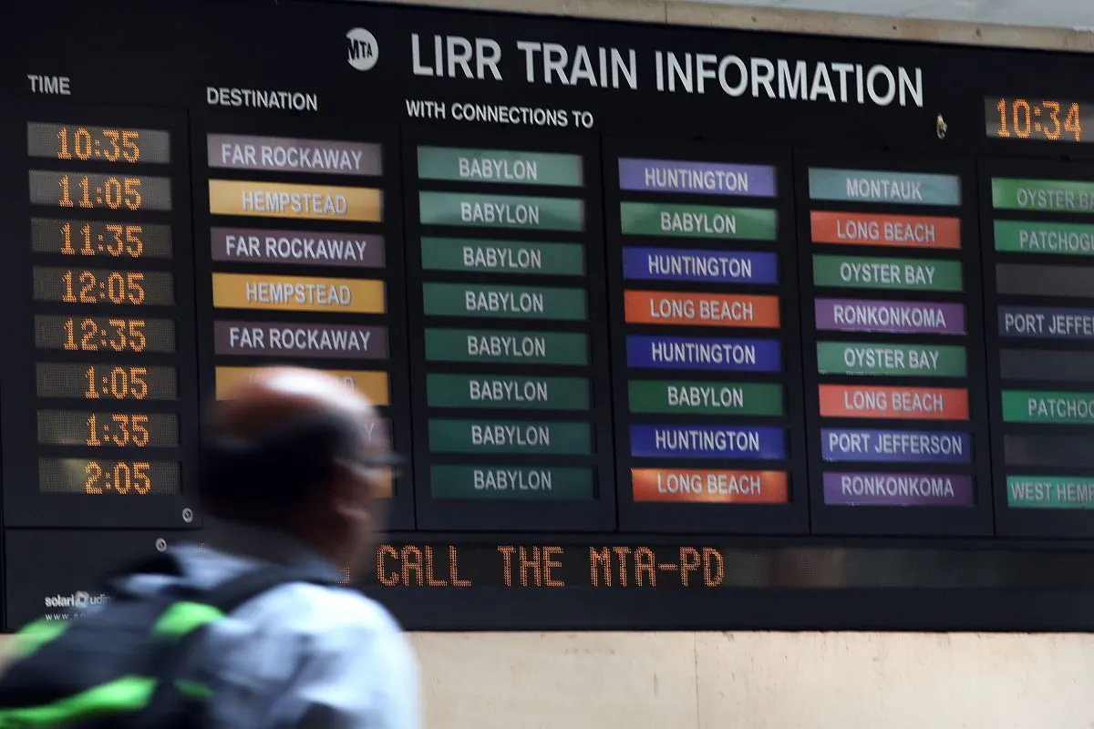 In this file photo, a man walks by a Long Island Rail Road (LIRR) schedule board on July 15, 2014 in the Brooklyn borough of New York City. (Spencer Platt/Getty Images)