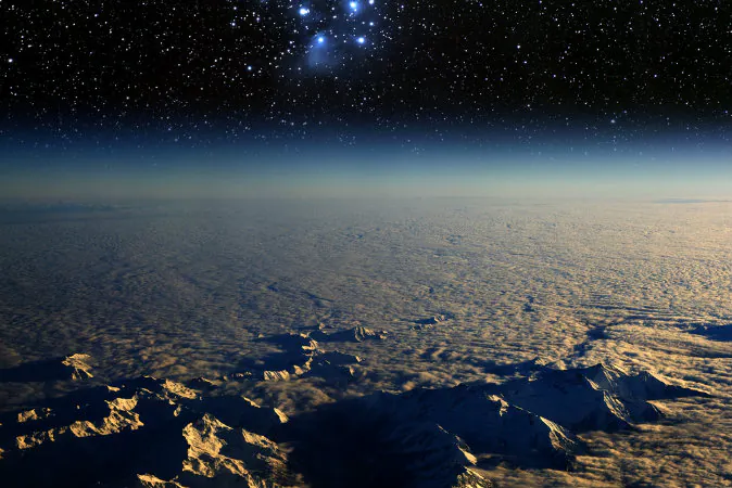 A high-altitude view of the Earth in space and the Pleiades star cluster. (Shutterstock*)