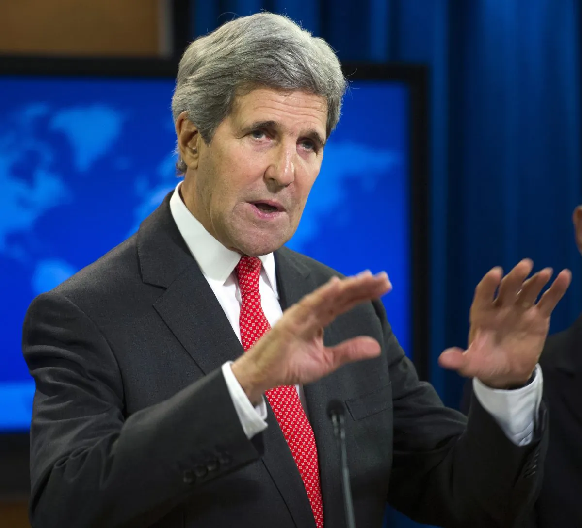 U.S. Secretary of State John Kerry speaks at a news conference to announce the 2013 Annual Report on International Religious Freedom in Washington, D.C., on Monday, July 28. The report states millions of people were displaced from their homes because of their religious beliefs last year. (AP Photo/Cliff Owen)