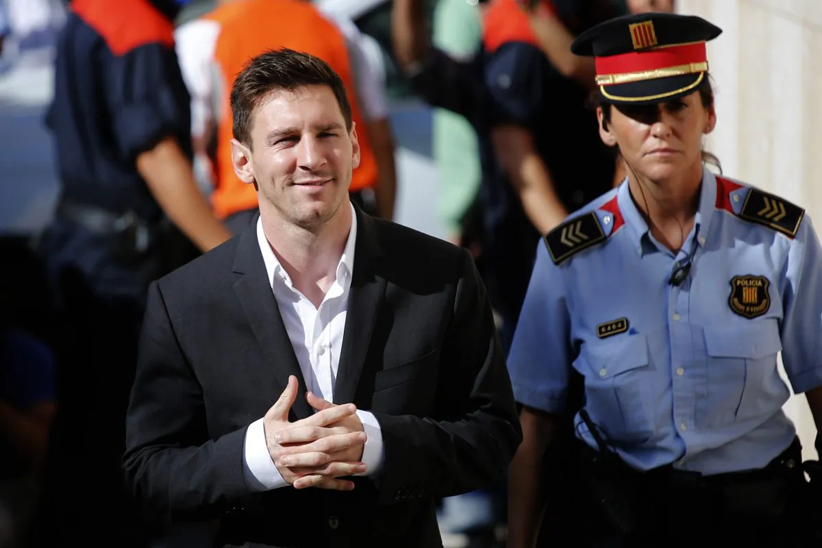FC Barcelona star Lionel Messi, left, arrives at a court to answer questions in a tax fraud case in Gava, near Barcelona, Spain, on Sept. 27, 2013. (AP Photo/Emilio Morenatti)