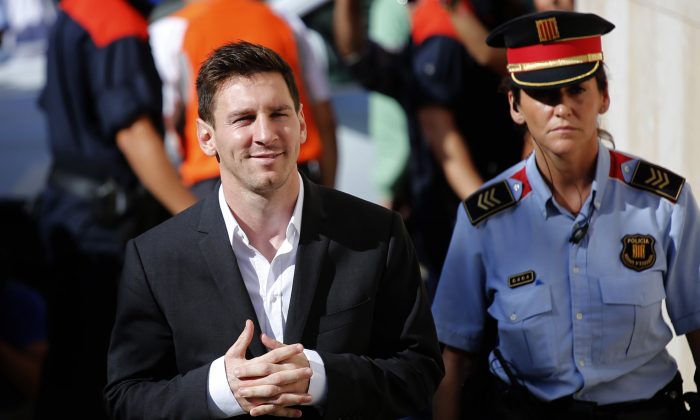 FC Barcelona star Lionel Messi, left, arrives at a court to answer questions in a tax fraud case in Gava, near Barcelona, Spain, on Sept. 27, 2013. (AP Photo/Emilio Morenatti)