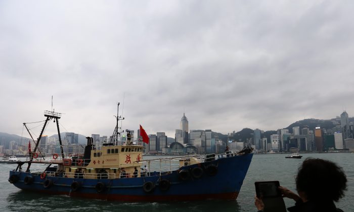 A Chinese fishing boat, which landed on one of Japan's Senkaku islands, sails into Victoria Harbor in Hong Kong on November 13, 2013. Through a new system, China is militarizing its fishing ships. (Aaron Tam/AFP/Getty Images) 