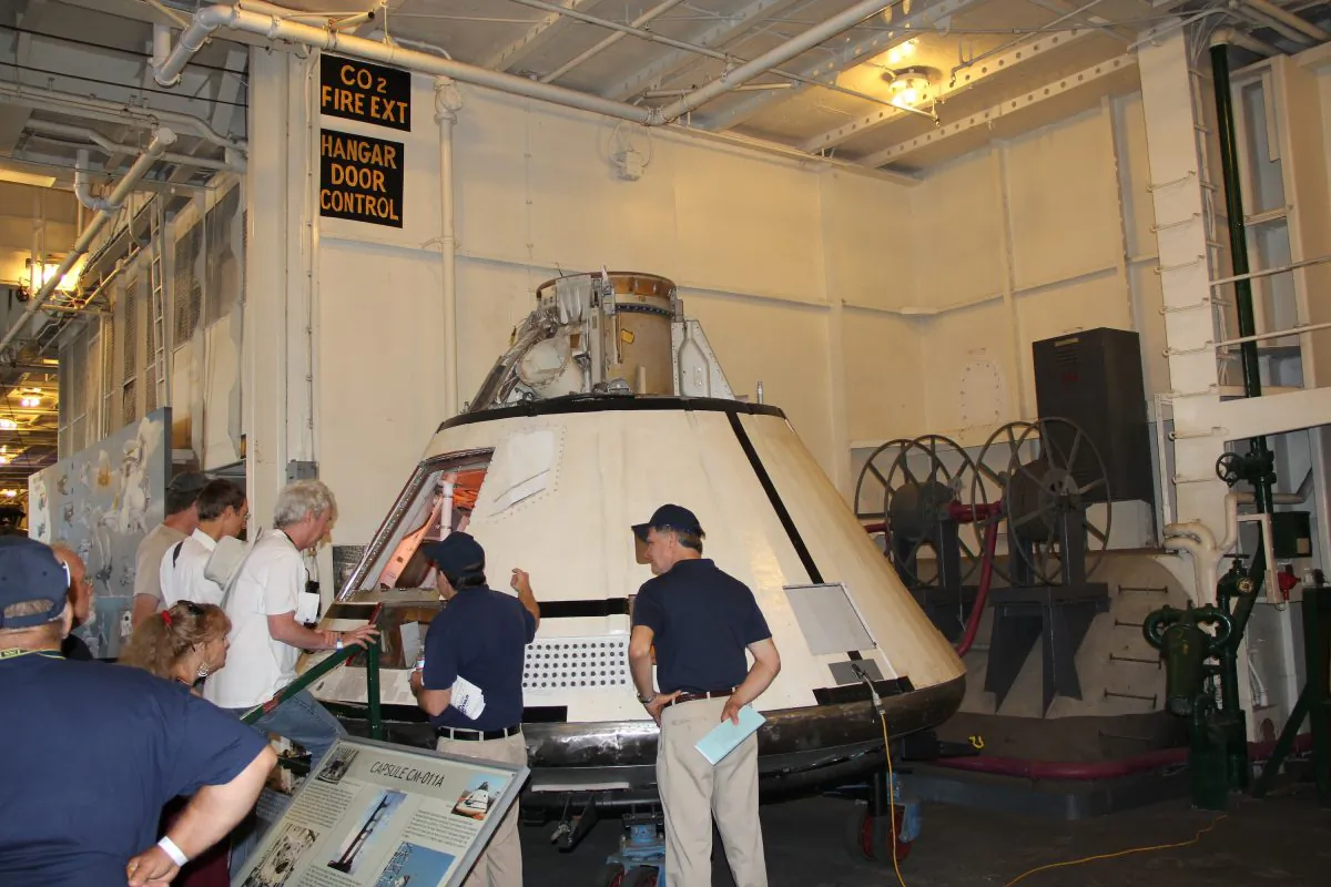 Visitors look at the lunar module or “capsule CM-011A” during the “Splashdown 45” event aboard the USS Hornet in Alameda, Calif., on July 26. (Steve Ispas/Epoch Times) 