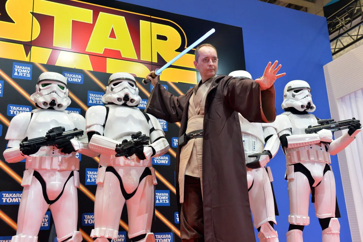 Japan's toy maker Tomy executive vice president and new chief operating officer (COO) Harold George Meij (C) poses with stom troopers as they introduce the new line up of Star Wars toys at the Tokyo Toy Show in Tokyo on June 12, 2014. Consumers are rebelling against the new Star Wars but Lucasfilm doesn't have to yield to them. (YOSHIKAZU TSUNO/AFP/Getty Images)