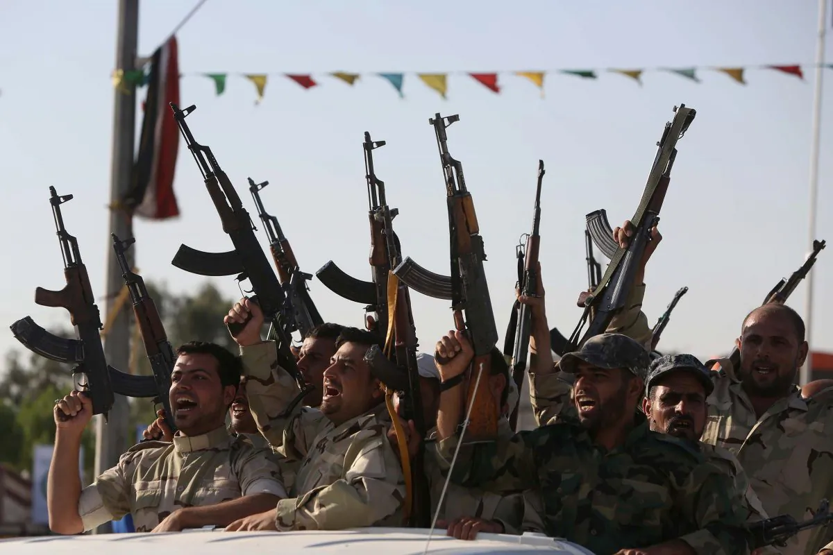 Members of the Al-Abbas brigades, who volunteered to protect the Shiite Muslim holy sites in Karbala against Sunni militants fighting the Baghdad government, parade in the streets of the Shrine city on June 26, 2014. (Mohammed Sawaf/AFP/Getty Images)