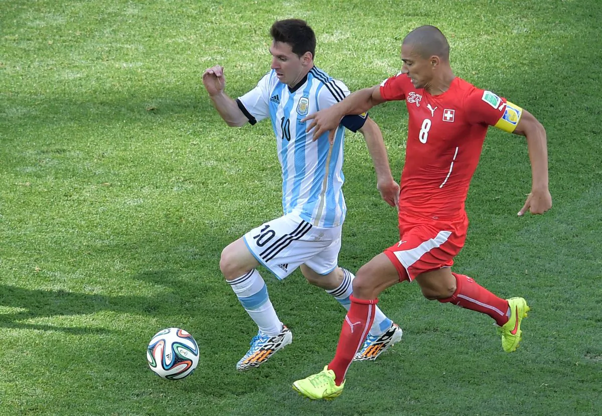 Argentina's forward and captain Lionel Messi (L) is challenged by Switzerland's midfielder and captain Goekhan Inler during the second half of a Round of 16 football match between Argentina and Switzerland at Corinthians Arena in Sao Paulo during the 2014 FIFA World Cup on July 1, 2014. (Gabriel Bouys/AFP/Getty Images)