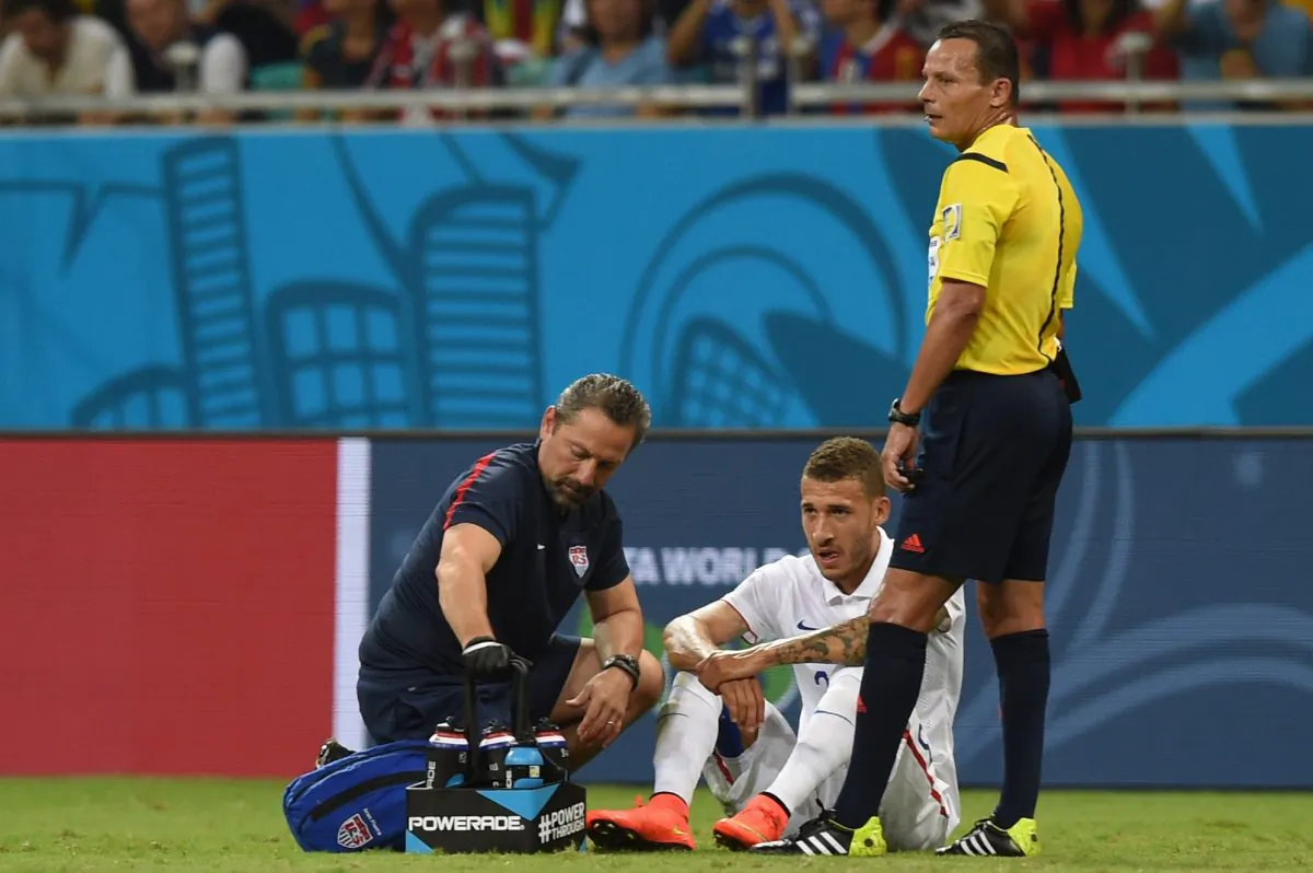 US defender Fabian Johnson (C) is treated by medical staff during a Round of 16 football match between Belgium and USA at Fonte Nova Arena in Salvador during the 2014 FIFA World Cup on July 1, 2014. (FRANCISCO LEONG/AFP/Getty Images)