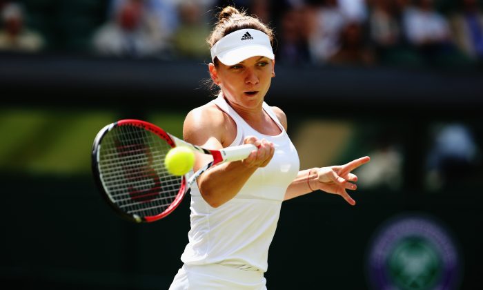 Simona Halep of Romania plays a forehand return during her Ladies' Singles quarter-final match against Sabine Lisicki of Germany on day nine of the Wimbledon Lawn Tennis Championships at the All England Lawn Tennis and Croquet Club at Wimbledon on July 2, 2014 in London, England. (Photo by Jan Kruger/Getty Images)