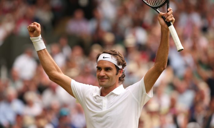 Switzerland's Roger Federer celebrates winning his men's singles quarter-final match against Switzerland's Stanislas Wawrinka on day nine of the 2014 Wimbledon Championships at The All England Tennis Club in Wimbledon, southwest London, on July 2, 2014. Federer won 3-6, 7-6(5), 6-4, 6-4. (ANDREW YATES/AFP/Getty Images)