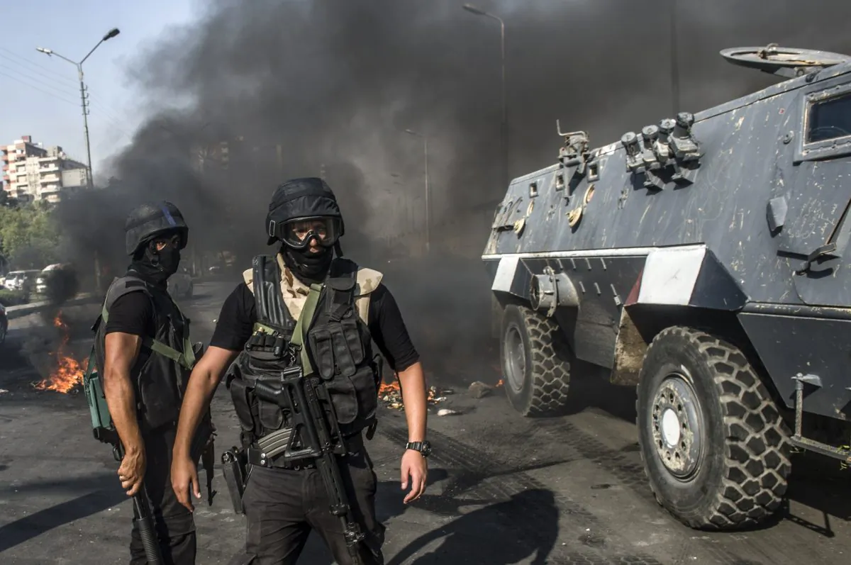 Egyptian riot policemen secure a street near an armoured vehicle during a rally of supporters of the Muslim Brotherhood movement to mark the first anniversary of the military ouster of president Mohamed Morsi on July 3, 2014 in Cairo's Ain Shams district. Egyptian police swiftly quashed Islamist protests firing tear gas and arresting dozens of demonstrators, as the protests are seen as a test of the Islamists' strength, with the Muslim Brotherhood-led Anti Coup Alliance having issued an aggressive rallying cry demanding a 'day of anger' to mark Morsi's overthrow. (Khaled Desouki/AFP/Getty Images)