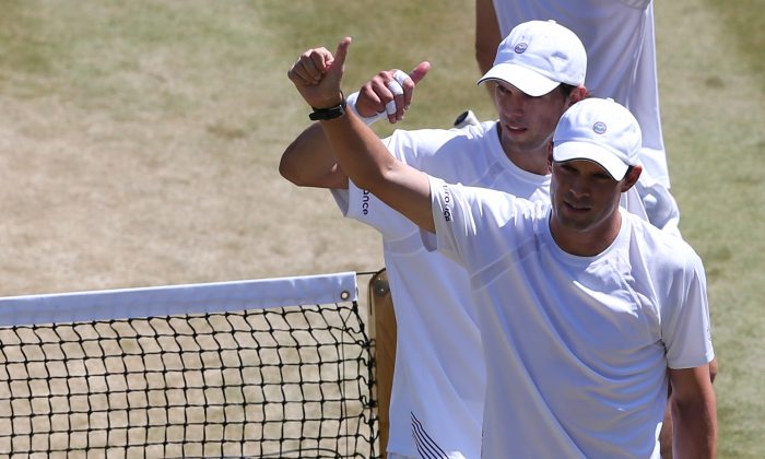 US players Bob Bryan and Mike Bryan celebrate after winning their men's doubles semi-final match against France's Nicolas Mahut and Michael Llodra on day 11 of the 2014 Wimbledon Championships at The All England Tennis Club in Wimbledon, southwest London, on July 4, 2014. The Bryan brothers won 7-6, 6-3, 6-2. (ANDREW COWIE/AFP/Getty Images)