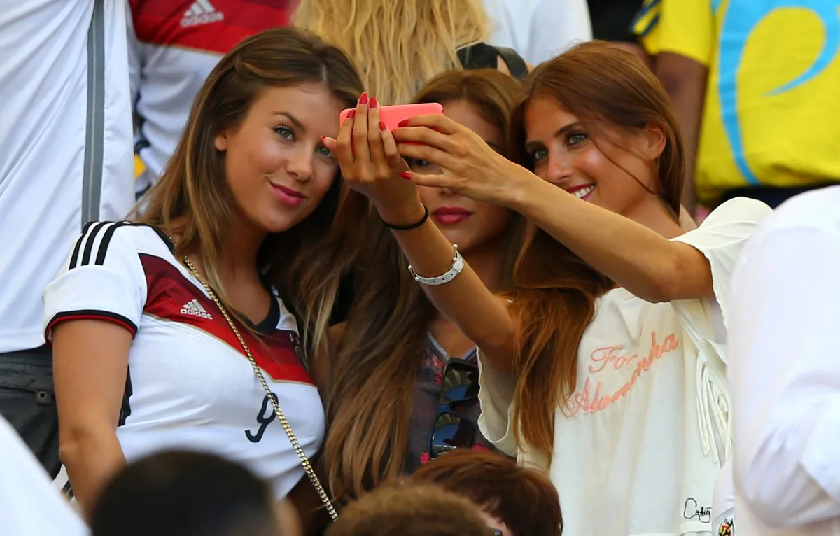  (L-R) Montana Yorke, girlfriend of Andre Schuerrle of Germany, Ann-Kathrin Brommel, girlfriend of Mario Gotze of Germany, and Cathy Fischer, girlfriend of Mats Hummels of Germany, take a selfie during the 2014 FIFA World Cup Brazil Quarter Final match between France and Germany at Maracana on July 4, 2014 in Rio de Janeiro, Brazil. (Martin Rose/Getty Images)