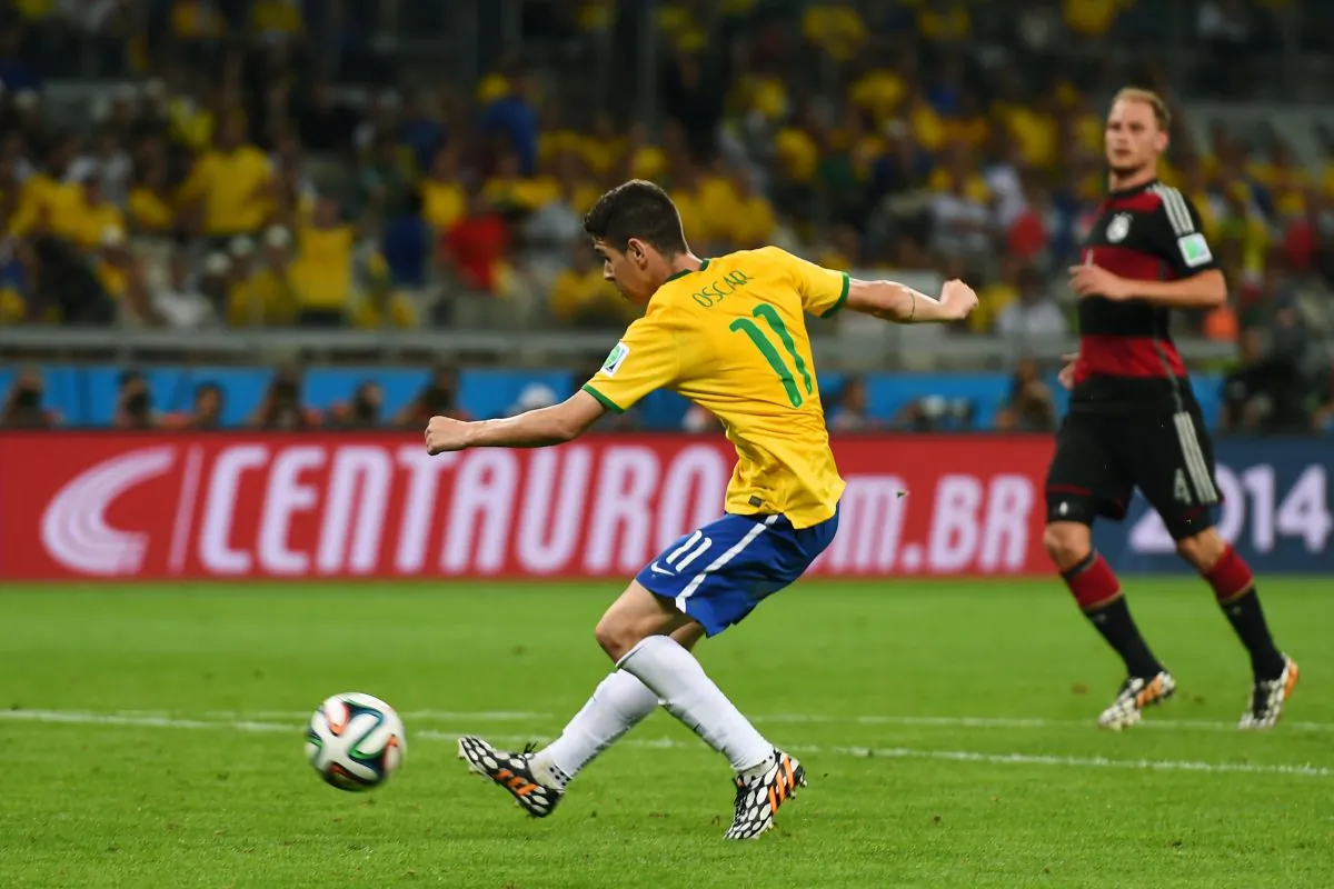 Oscar of Brazil shoots and scores his team's first goal during the 2014 FIFA World Cup Brazil Semi Final match between Brazil and Germany at Estadio Mineirao on July 8, 2014 in Belo Horizonte, Brazil. (Buda Mendes/Getty Images)