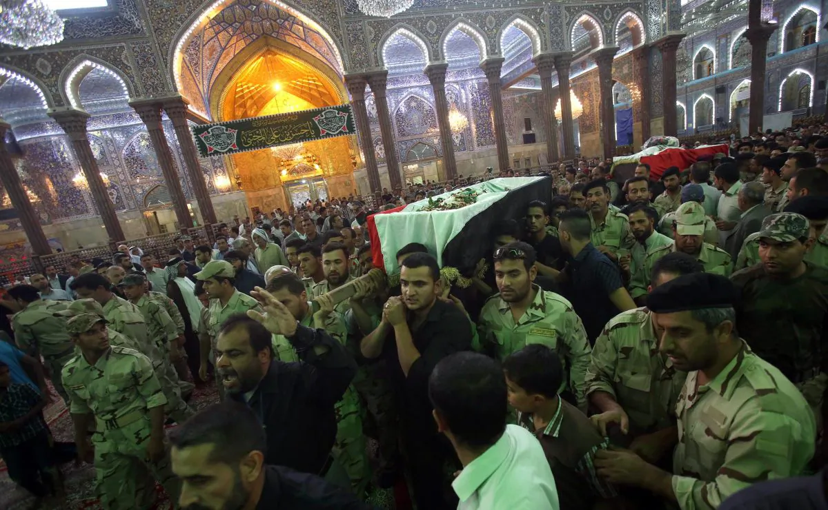 Iraqi mourners carry the coffins of locals killed in fighting in the predominantly-Sunni Muslim city of Samarra, during their funeral in the holy city of Karbala, 80 kilometers (50 miles) south of Baghdad, on July 12, 2014. Iraqi forces and tribal fighters beat back a fresh assault by Sunni militants on the town of Haditha, strategic for the large nearby dam and its oil refinery, police said. (Mohammed Sawaf/AFP/Getty Images)
