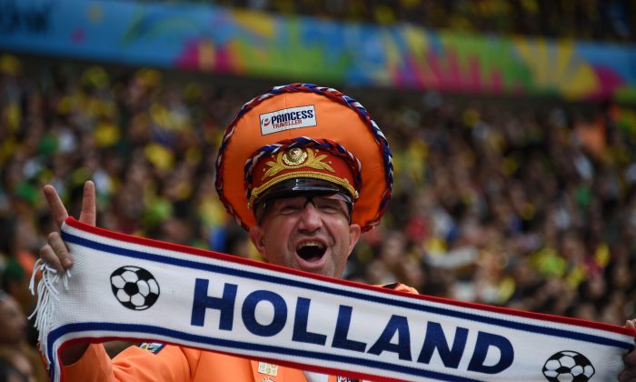 A Netherlands fan cheers for his team during the third place play-off football match between Brazil and Netherlands during the 2014 FIFA World Cup at the National Stadium in Brasilia on July 12, 2014. (Vanderlei Almeida/AFP/Getty Images)