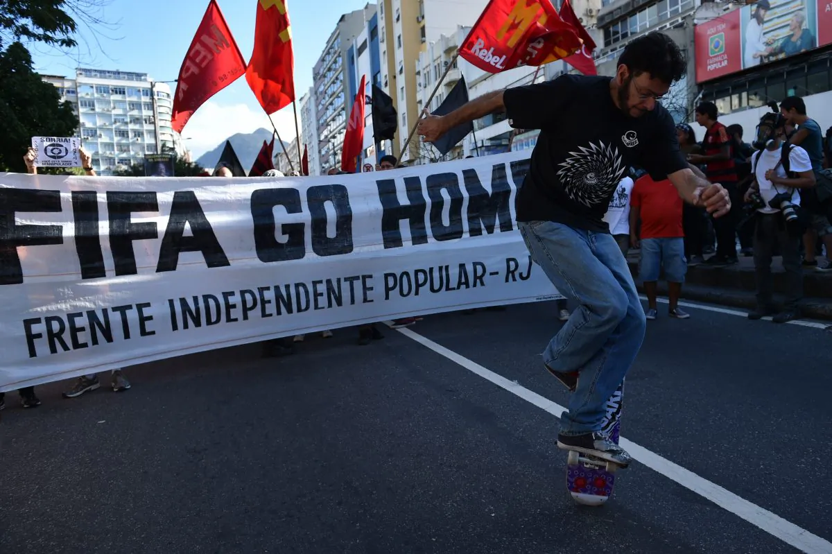 Demonstrators protest against the FIFA World Cup to demand better social services near the Maracana Stadium in Rio de Janeiro on July 13, 2014. Danny Schechter reports the World Cup left Brazil with large debts and intensified social tensions. (Yasuyoshi Chiba/AFP/Getty Images)
