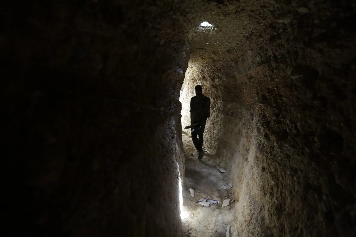 A Syrian army soldier makes his way in a tunnel reportedly previously used by rebel fighters in Jobar, a mostly rebel-held area on the eastern outskirts of Damascus on June 2, 2014. (Joseph Eid/AFP/Getty Images)