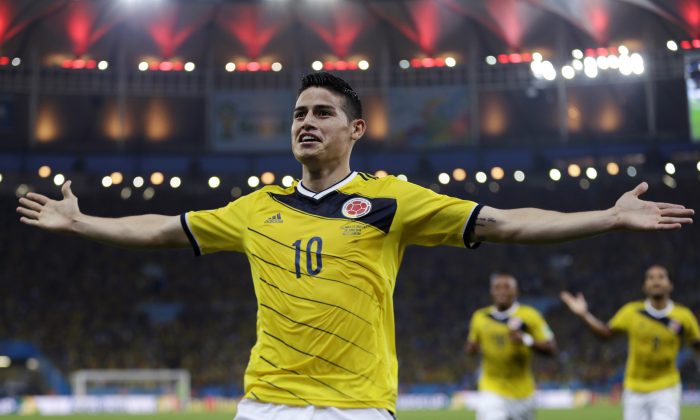 FILE - In this June 28, 2014, file photo, Colombia's James Rodriguez celebrates after scoring the opening goal during the World Cup round of 16 soccer match between Colombia and Uruguay at the Maracana Stadium in Rio de Janeiro, Brazil. Never before has the star-crossed nation made the quarterfinals. There is even waxing poetic about World Cup unity accelerating the pace of 18-month-old peace talks to end a half-century of conflict that has claimed some 220,000 lives. (AP Photo/Natacha Pisarenko)