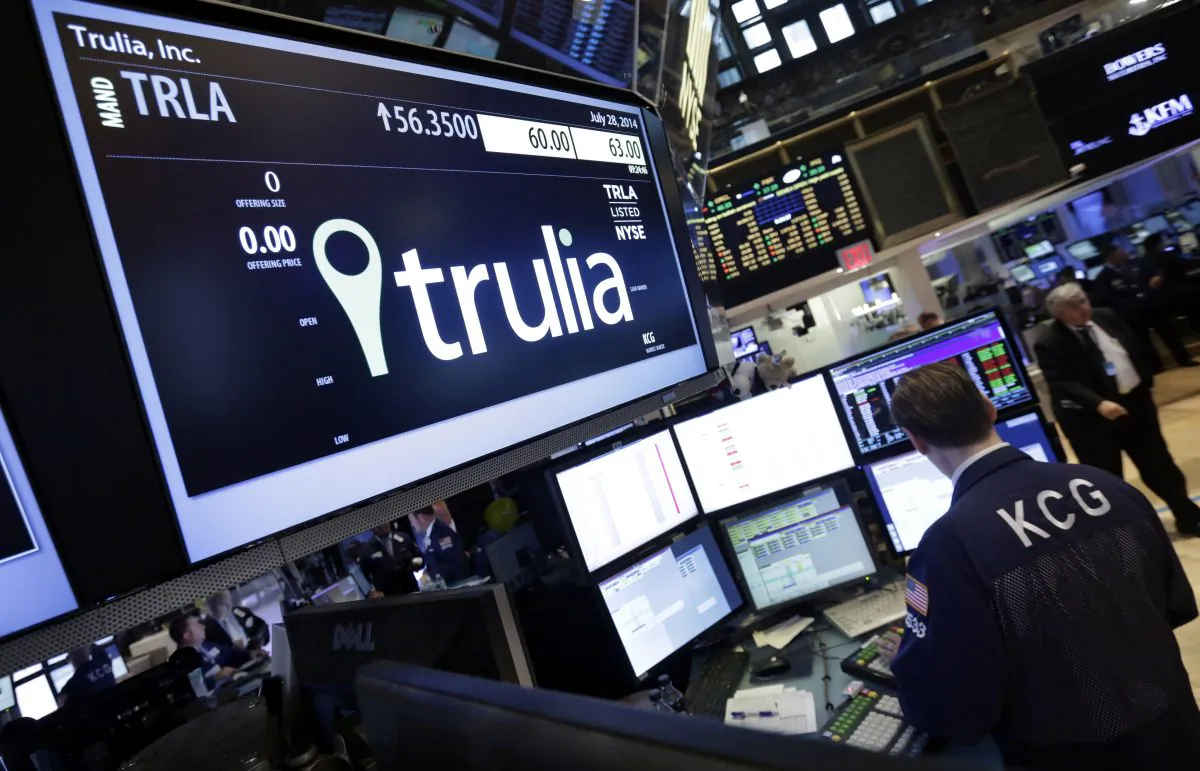 A specialist woks at the post that handles Trulia on the floor of the New York Stock Exchange, on July 28, 2014. Trulia jumped 11 percent after the real-estate listing service Zillow said it plans to buy it for $3.5 billion. (Richard Drew/AP Photo)