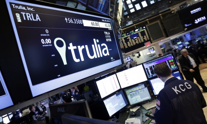 A specialist woks at the post that handles Trulia on the floor of the New York Stock Exchange, on July 28, 2014. Trulia jumped 11 percent after the real-estate listing service Zillow said it plans to buy it for $3.5 billion. (Richard Drew/AP Photo)