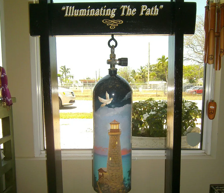 Scuba tank decorated with a lighthouse as a beacon. The work is titled â€˜Iuminating the Path,â€™ and is on display at Prana in Key Largo, Florida. (Myriam Moran copyright 2014)