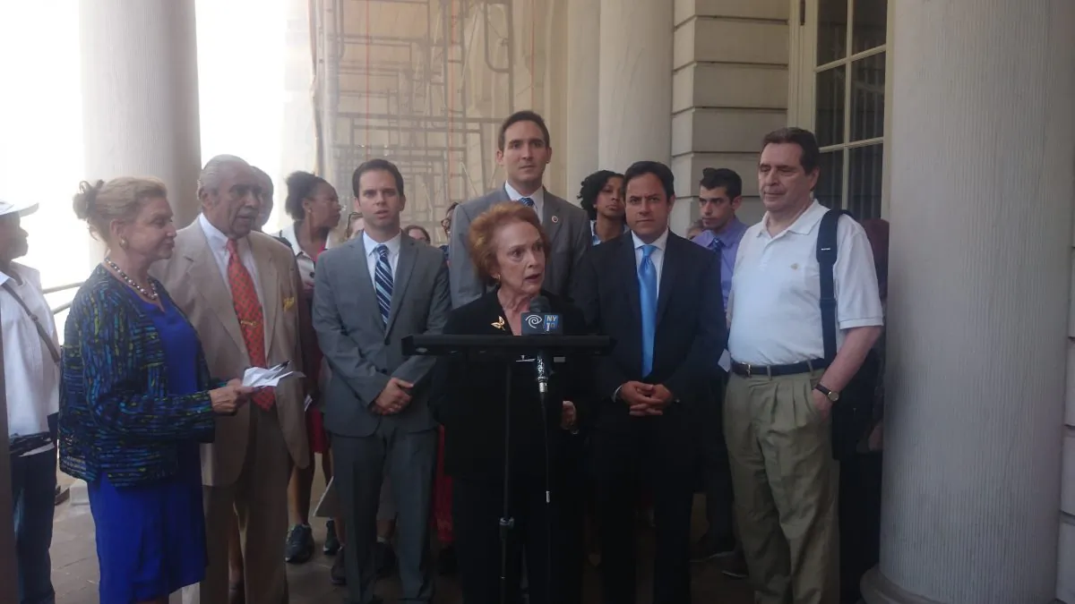 Federal, state, and city officials stand by residents who would be required to move to smaller units under the city Department of Housing and Preservation and Development's mandated downsizing of overhoused units at City Hall, July 2, 2014. (Catherine Yang/Epoch Times)