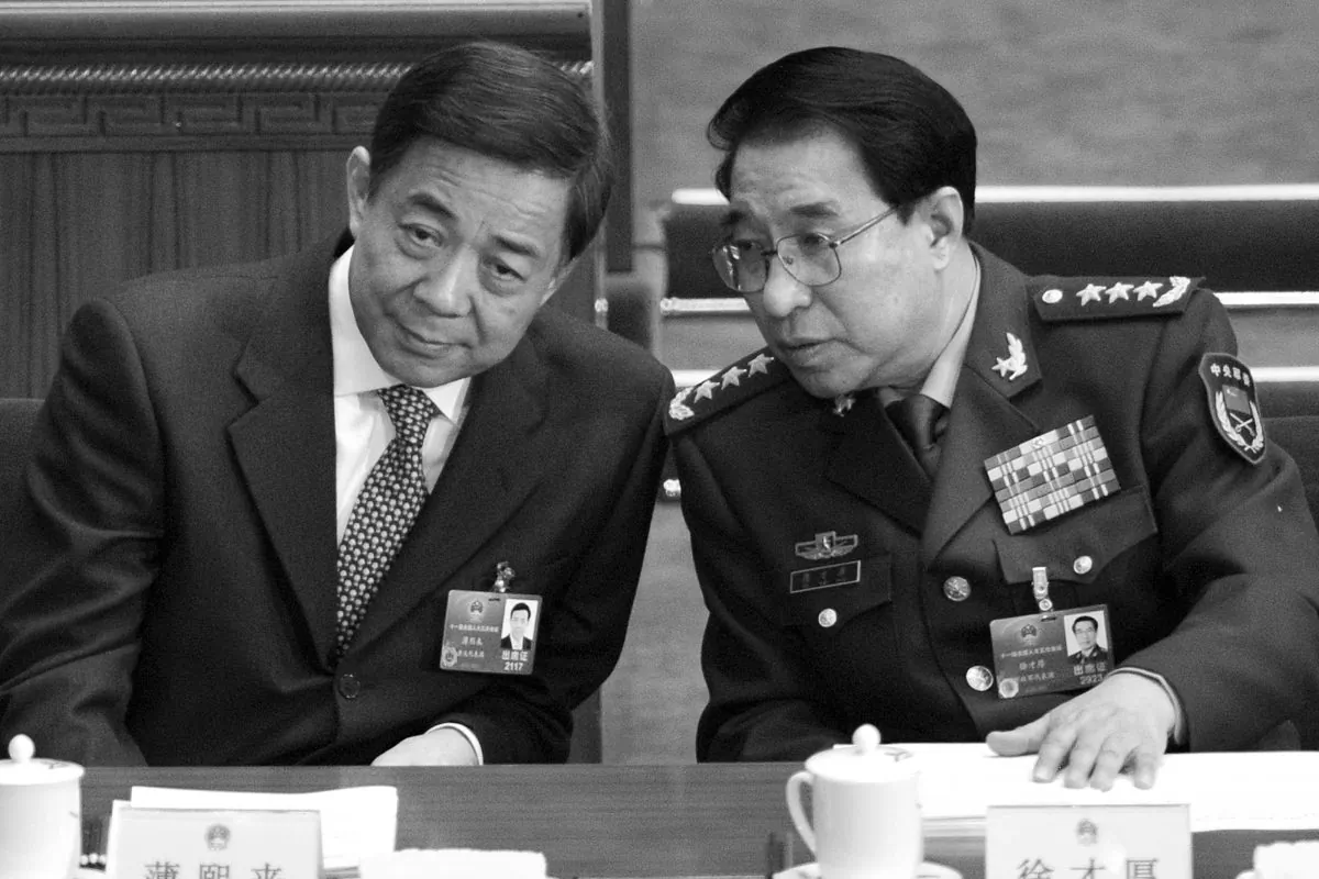 Disgraced Politburo member Bo Xilai (L) talks to Xu Caihou at the National People's Congress on March 5, 2012. A little over a month later, Bo Xilai was purged; on July 2, 2014, Xu was also expelled fro the Chinese Communist Party. (Liu Jin/AFP/Getty Images)