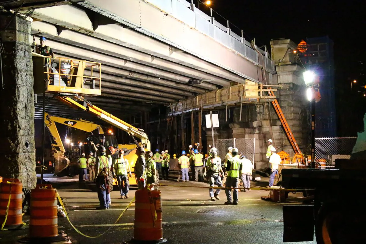 Construction workers performed emergency repair on a portion of the Washington and Prospect streets underpass of the Brooklyn Bridge, July 3. (Brendon Fallon/Epoch Times)
