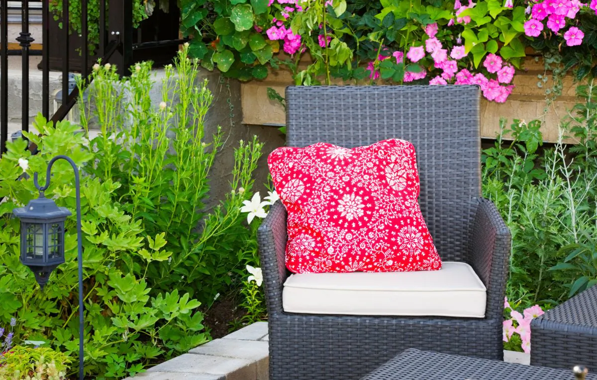  Plants placed in raised wooden beds, behind walls, or separate from walkways and patios are easier to manage. (Brenda Carson/Hemera/Thinkstock)