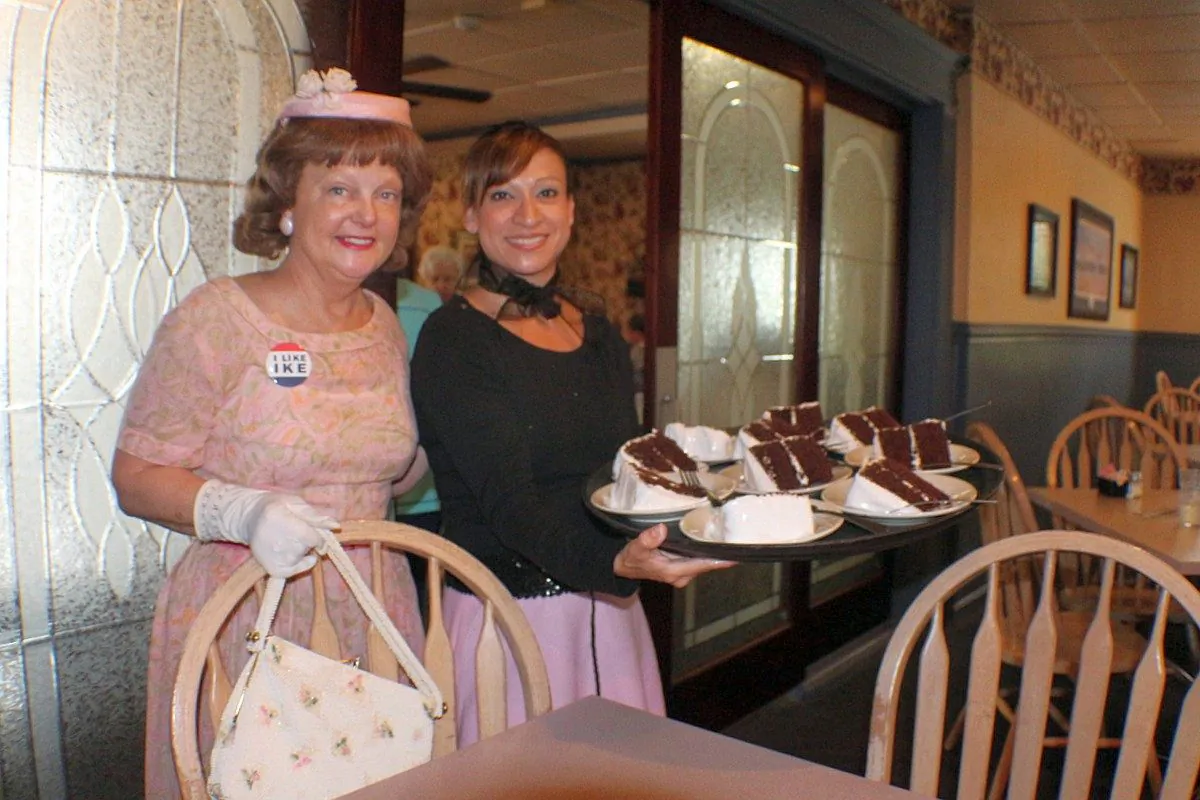 Ruthmary McIlhenny as Mamie Eisenhower with Dunlap Restaurant server Stacy Chavira with tray of Mamie's recipe chocolate cake. (Myriam Moran copyright 2014)