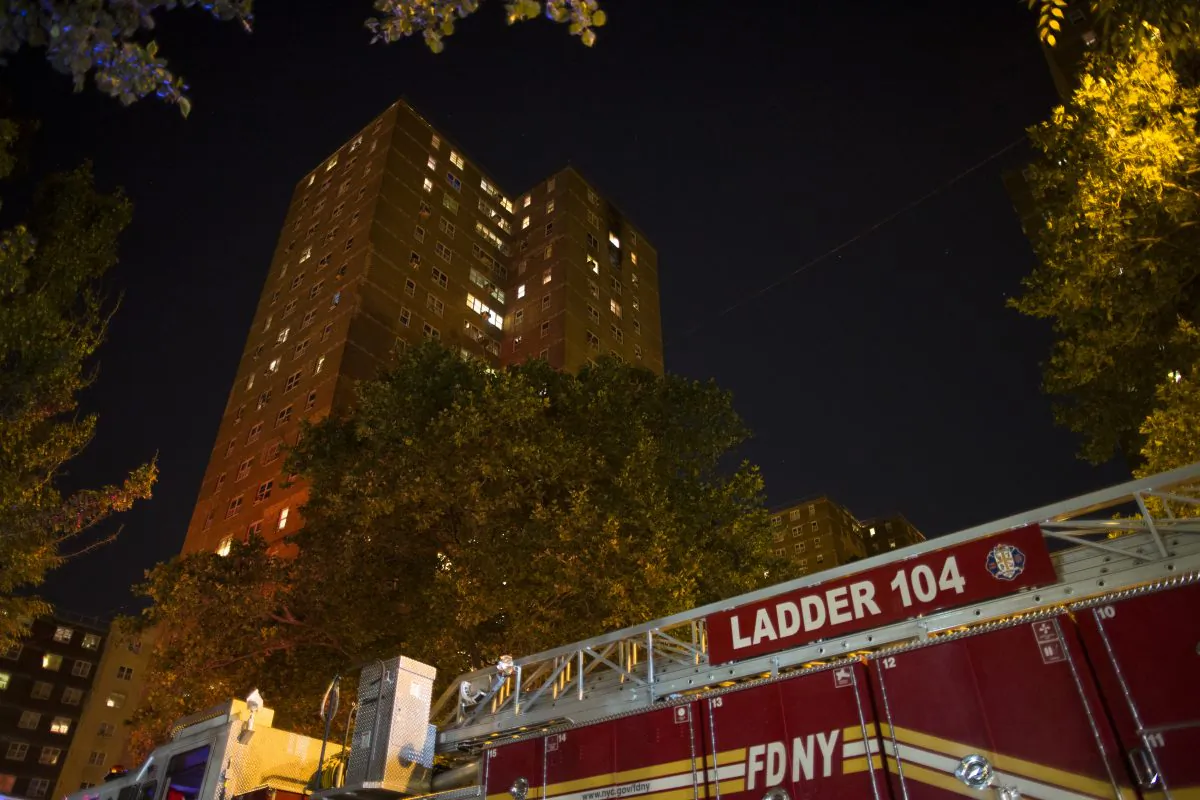 A fire truck at the scene of a fire at public-housing high-rise early Sunday, July 6, 2014, in Brooklyn, New York. (John Minchillo/AP)