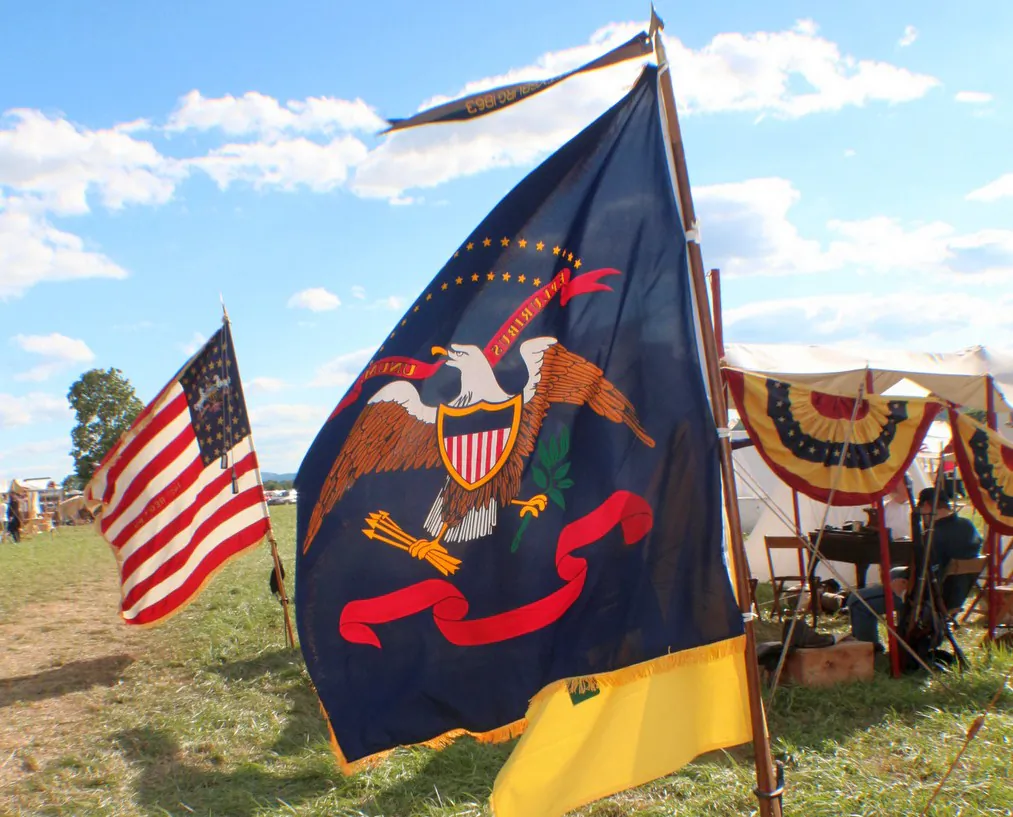 Flags and banners blow in the wind as drum rolls and bugle calls bring reenactors to the field at Gettysnburg, Pennsylvania for the 151st Anniversary of the Civil War battle fought here. (Myriam Moran copyright 2014)