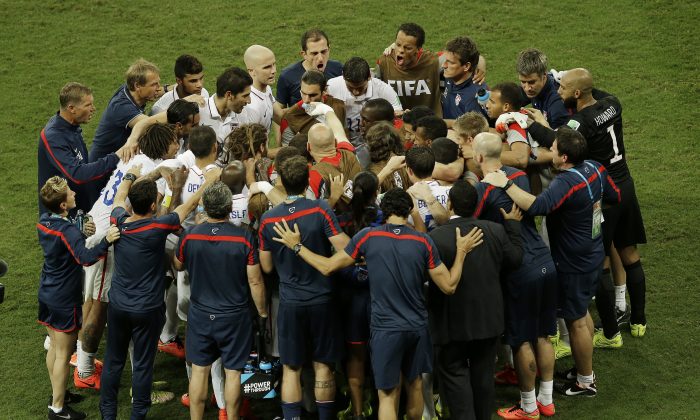 The U.S. team huddles before the beginning of the extra time during the World Cup round of 16 soccer match between Belgium and the USA in Salvador, Brazil, on July 1, 2014. (AP Photo/Themba Hadebe)
