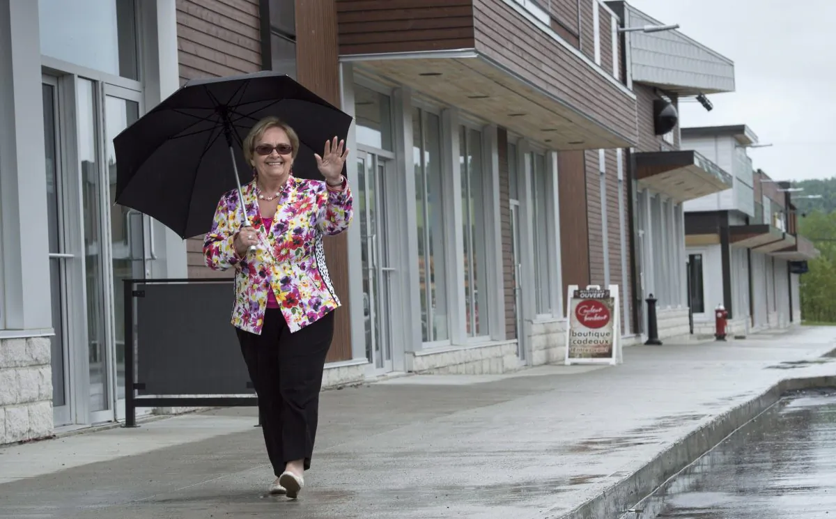 Mayor Colette Roy Laroche walks along the street of Lac-Megantic’s new downtown core on June 10, 2014. One year after a runaway train destroyed part of the Québec town, echoes of the disaster still haunt people in the region. (The Canadian Press/Paul Chiasson)