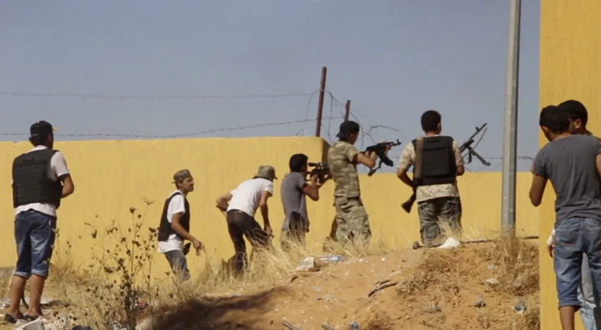 In this Saturday, July 26, 2014 frame grab from video obtained from a freelance journalist traveling with the Misarata brigade, fighters from the Islamist Misarata brigade fire towards Tripoli airport in an attempt to wrest control from a powerful rival militia, in Tripoli, Libya. The battle for control of Tripoli's international airport began two weeks ago when Islamist-led militias - mostly from the western city of Misrata - launched a surprise assault on the airport, under control of rival militias from the western mountain town of Zintan. Heavy clashes in the country’s restive east between Libyan soldiers loyal to a renegade general and Islamist-led militias killed dozens of people including civilians, health officials said Sunday. On Saturday, the U.S. evacuated its diplomats in Tripoli to neighboring Tunisia and shut its embassy. (AP Photo/AP video)