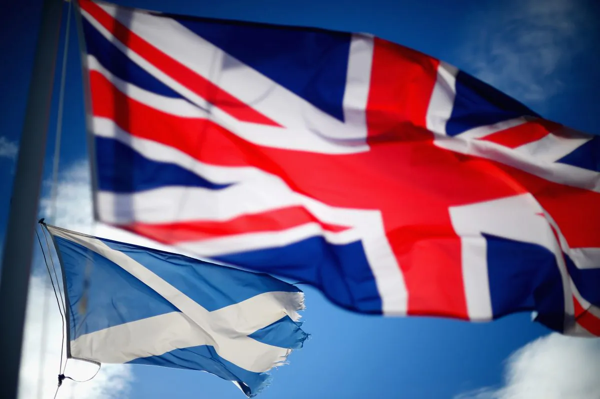 A Union Jack and Scotland's flag, the Saltire, blow in the wind near to Glen Coe, Scotland on March 24, 2014. Scotland prepares for the independence vote on September 18th. (Jeff J Mitchell/Getty Images)
