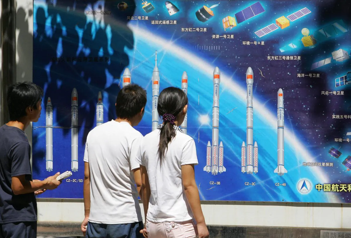 People look at a display of China's rockets and space program on Aug. 29, 2007, in a Beijing park. The Chinese regime recently tested an anti-satellite missile. (Frederic J. Brown/AFP/Getty Images) 