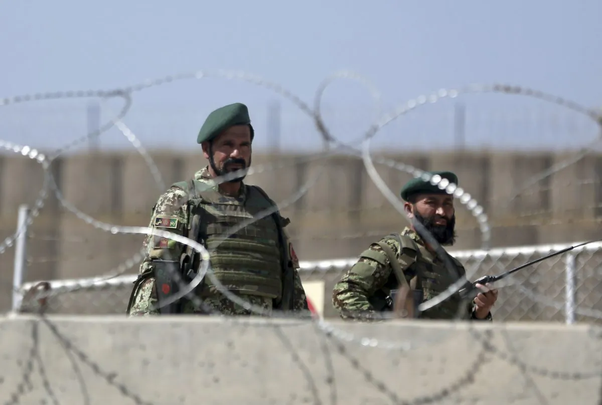 Afghanistan National Army soldiers stand guard at a gate of Camp Qargha, west of  Kabul, Afghanistan, Tuesday, Aug. 5, 2014. (AP Photo/Massoud Hossaini)