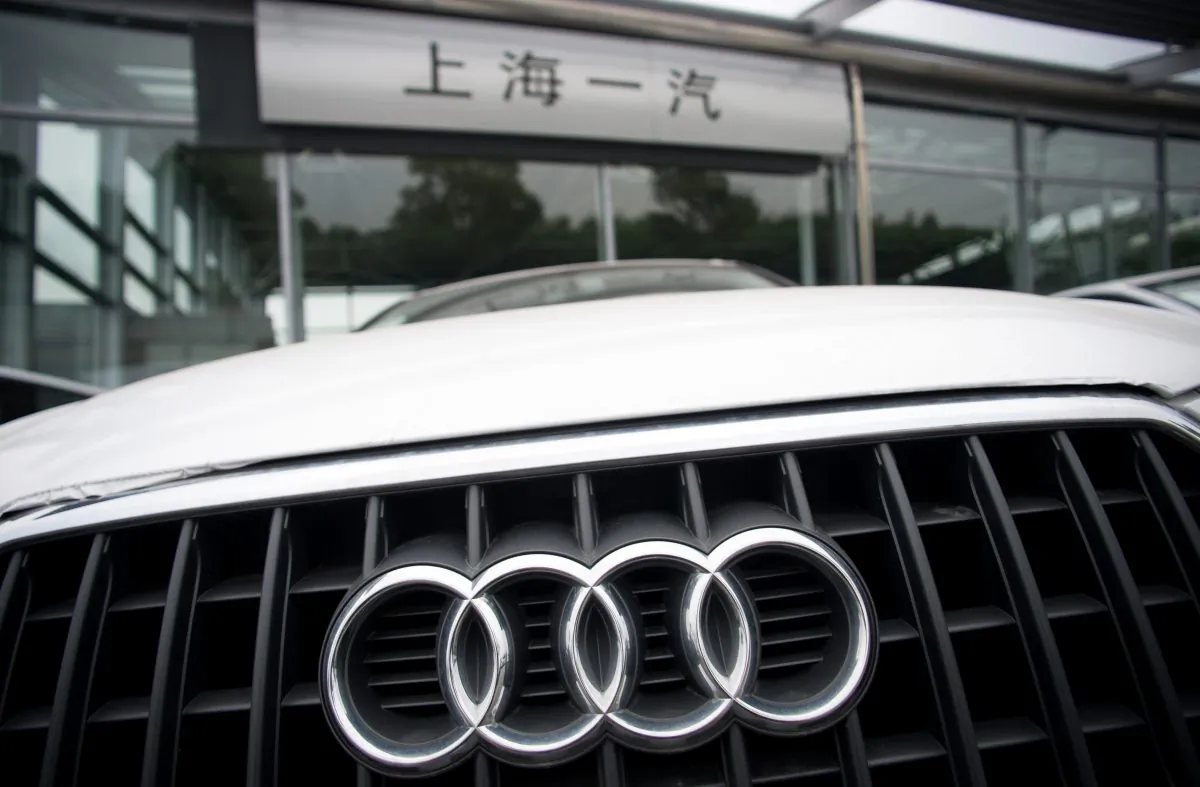 An Audi is pictured in front of a car dealer in Shanghai on Aug. 6, 2014. German luxury car maker Audi and Chrysler of the United States have committed 'monopoly behaviour' in China and will be punished soon, the country's regulator said. (Johannes Eisele/AFP/Getty Images) 