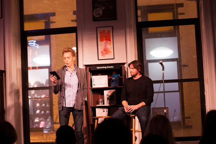 Joshua Fields Millburn regales the audience while Ryan Nicodemis looks on during a speaking engagement in New York City. Since paying off their debt and simplifying their lives five years ago, the two have become have become poster boys of sorts for the minimalist movement. (Courtesy of The Minimalists)