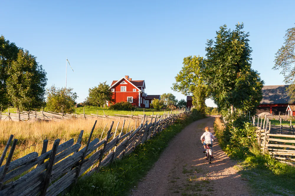 Child riding a bicycle along a small farm lane in rural Sweden. (*Shutterstock)