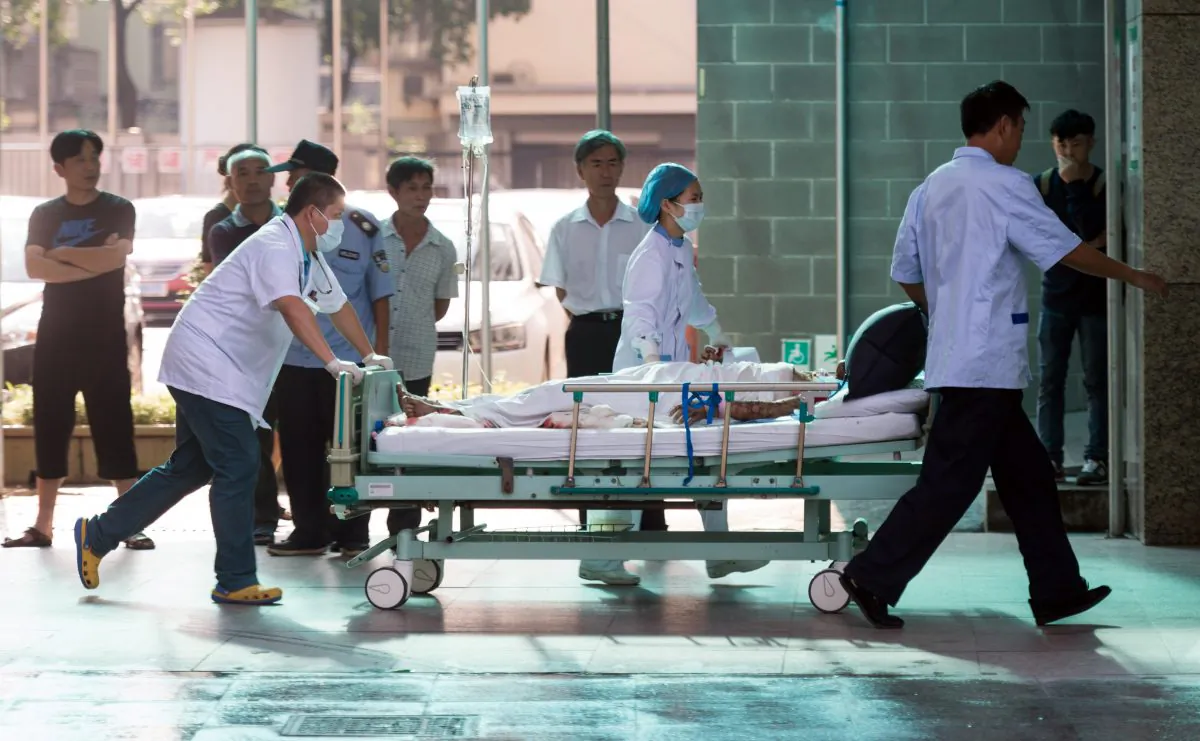 Doctors and nurses rush a victim of a factory explosion for treatment at a hospital in Kunshan in eastern China on Aug. 2, 2014. (Johannes Eisele/AFP/Getty Images)