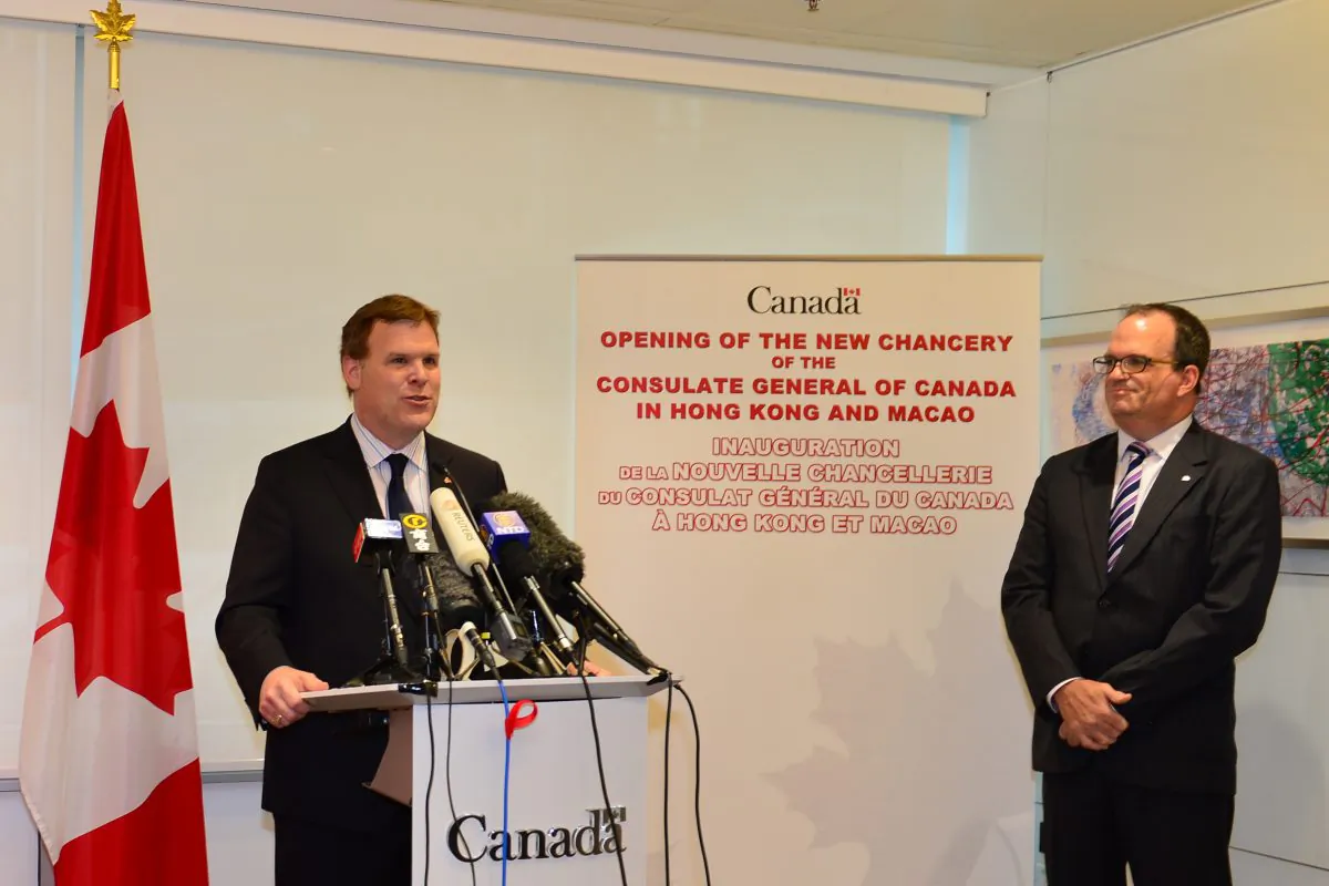 Canadian Foreign Minister, the Hon. John Baird addressing media and guests at the opening of the new Canadian Consular Office at 5/F, Tower 3, Exchange Square, Hong Kong on Wednesday Aug 6 together with J. Ian Burchett, the Canadian Consul General of Hong Kong and Macau. (Bill Cox/Epoch Times)
