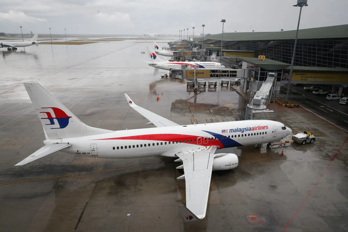 A Malaysia Airlines Boeing 737-800 plane sits on tarmac at Kuala Lumpur International Airport in Sepang, Malaysia, Friday, Aug. 8, 2014. (AP Photo/Vincent Thian)