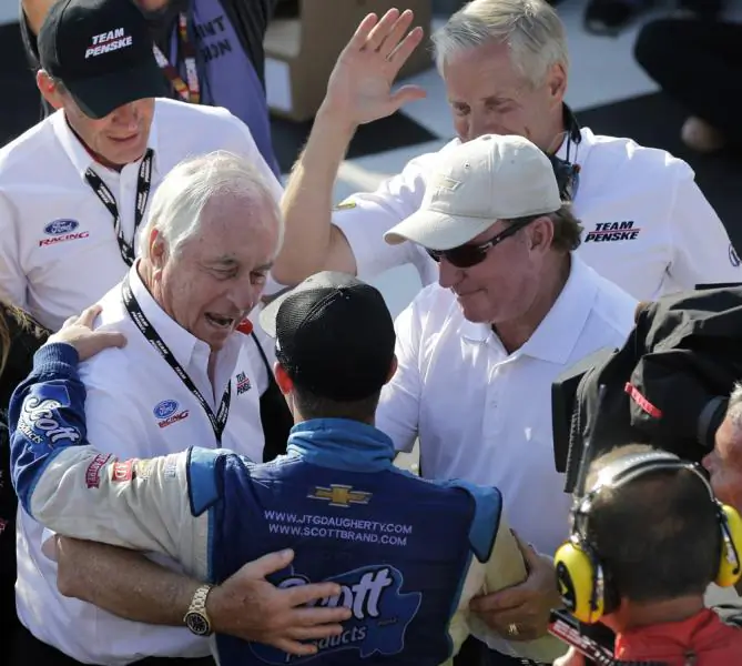 AJ Allmendinger is congratulated by team owners Roger Penske and Richard Childress.