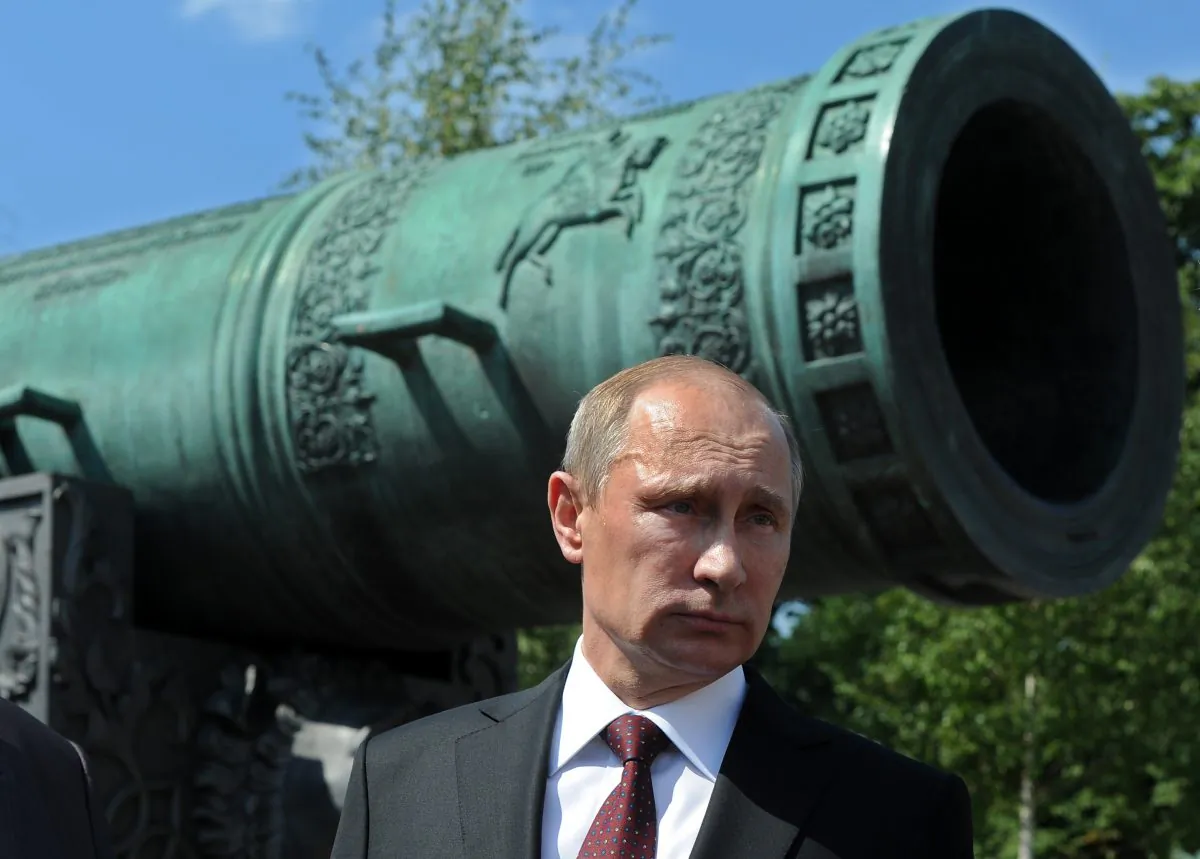 Russia's President Vladimir Putin stands in front of theTsar Pushka (Tsar Cannon), one of the Russian landmarks displayed in the Kremlin in Moscow, on July 31, 2014. (Mikhail Klimentyev/AFP/Getty Images)